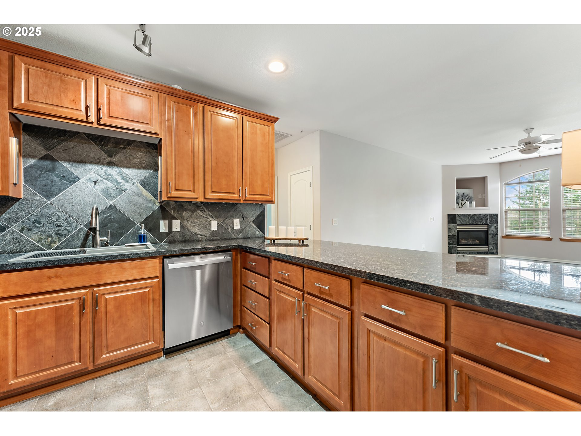 20508 Southwest Roy Rogers Road, Unit 328 Sherwood, OR 97140 - Photo 23 of 48 a kitchen with granite countertop a sink and cabinets