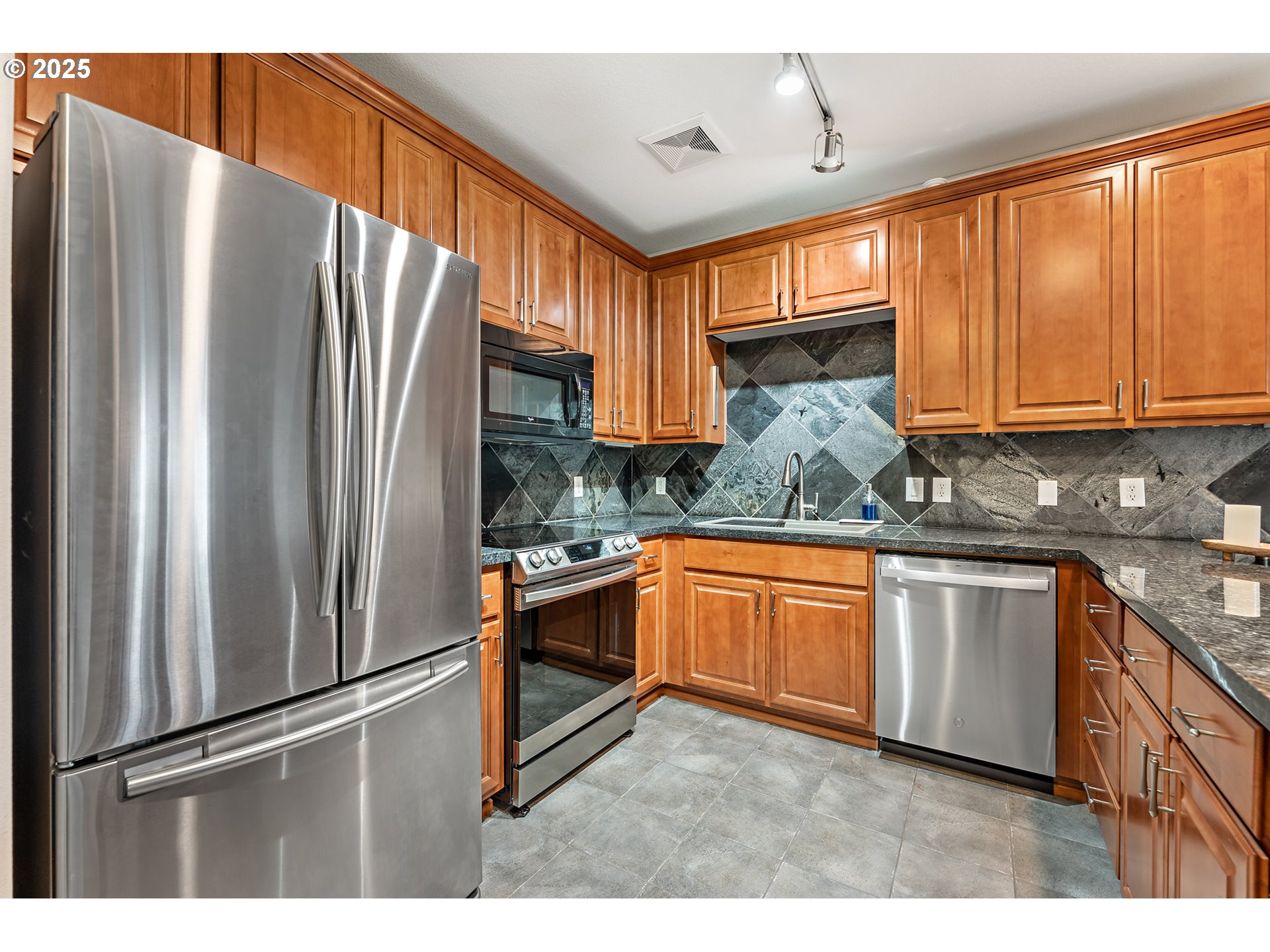 20508 Southwest Roy Rogers Road, Unit 328 Sherwood, OR 97140 - Photo 24 of 48 a kitchen with stainless steel appliances granite countertop a refrigerator and a sink
