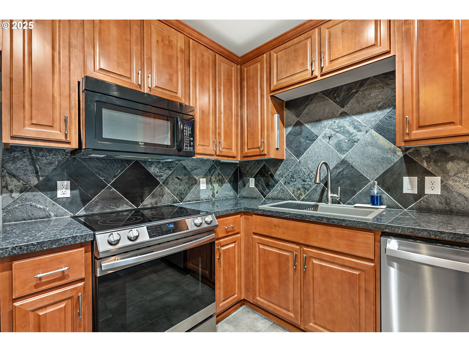 20508 Southwest Roy Rogers Road, Unit 328 Sherwood, OR 97140 - Photo 25 of 48 a kitchen with stainless steel appliances granite countertop a stove microwave and cabinets