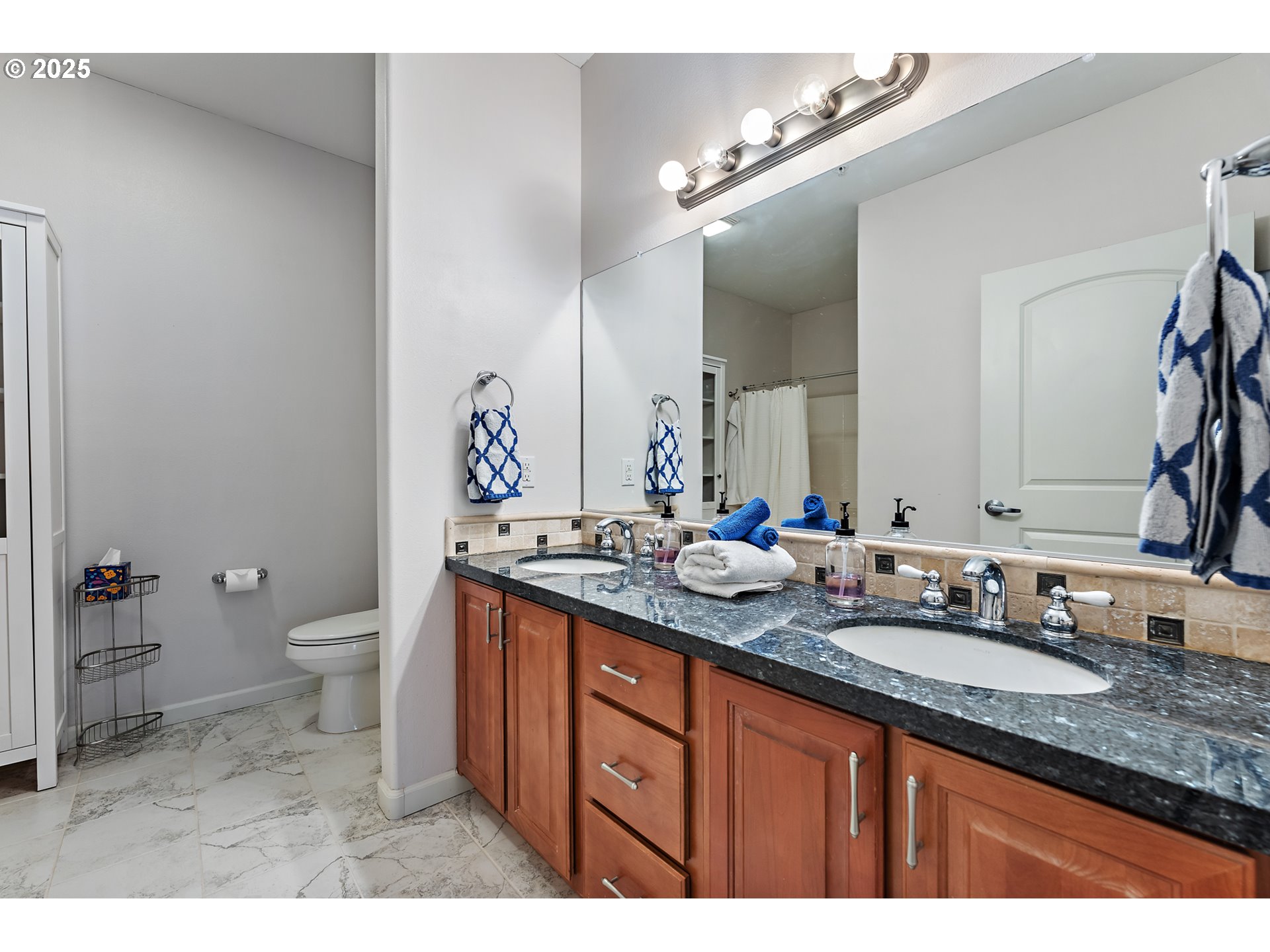20508 Southwest Roy Rogers Road, Unit 328 Sherwood, OR 97140 - Photo 33 of 48 a bathroom with a granite countertop sink a toilet and a mirror