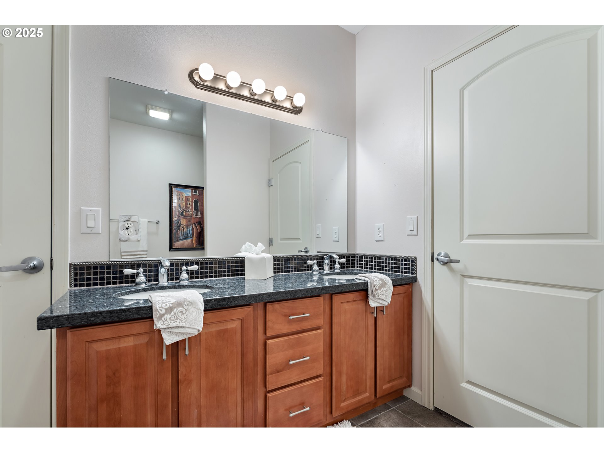 20508 Southwest Roy Rogers Road, Unit 328 Sherwood, OR 97140 - Photo 38 of 48 a bathroom with a granite countertop sink a large mirror and a