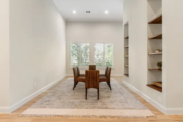 a dining room with furniture and window