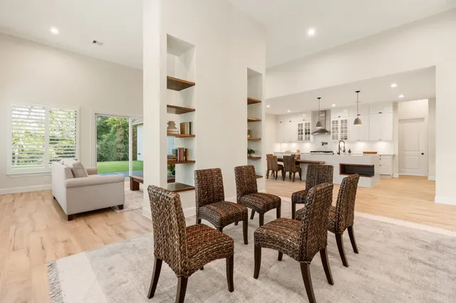 a dining room with furniture and a large window