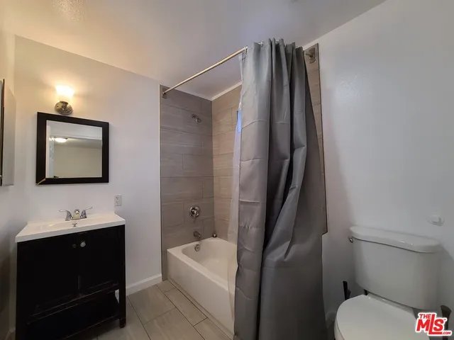a bathroom with a toilet a sink and bathtub