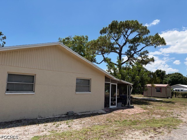 2175 Twin Brooks Road North Fort Myers, FL 33917 - Photo 16 of 27 a backyard of a house with wooden fence and a large tree