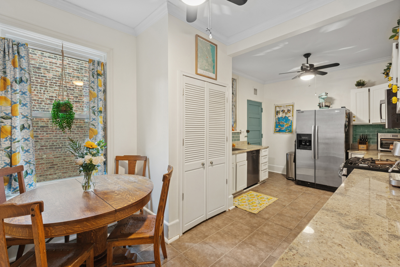 559 West Aldine Avenue, Unit 2 Chicago, IL 60657 - Photo 16 of 23 a kitchen with stainless steel appliances kitchen island granite countertop a refrigerator a stove a sink dishwasher with a dining table and chairs