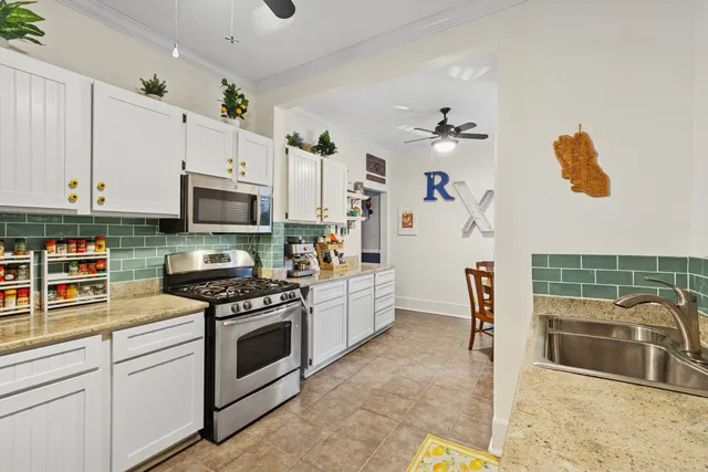 a kitchen with stainless steel appliances a refrigerator sink and stove