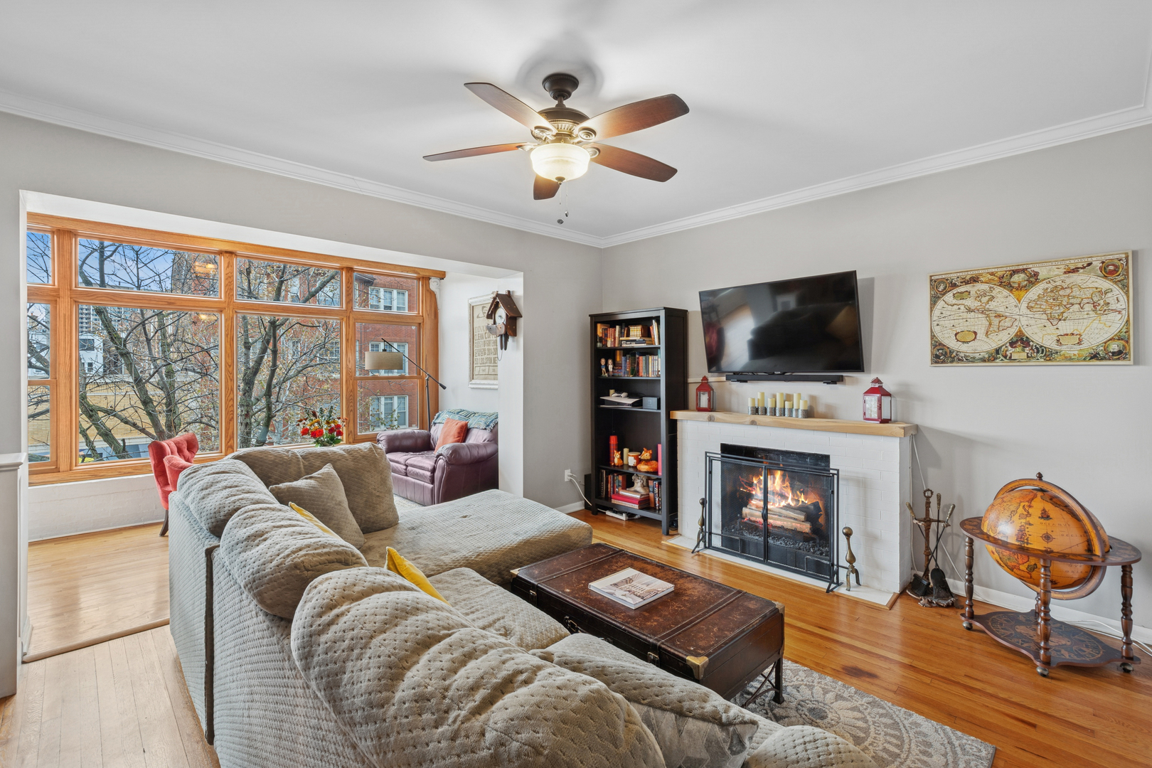 559 West Aldine Avenue, Unit 2 Chicago, IL 60657 - Photo 7 of 23 a living room with furniture a flat screen tv and a fireplace
