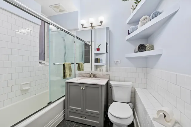 a view of a hallway with wooden floor and furniture