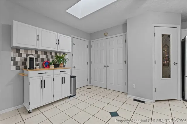 a view of a house with a yard and sitting area