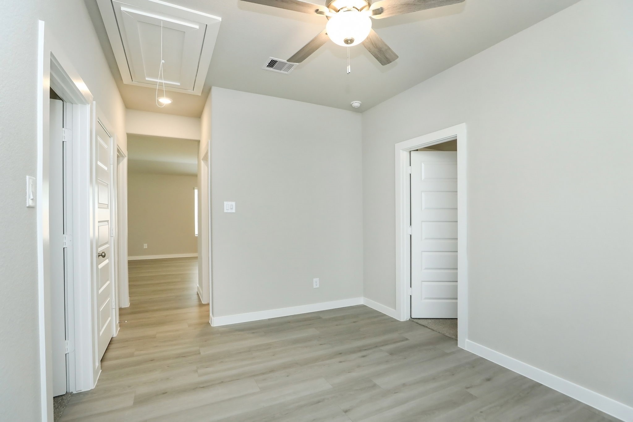 14110 Greystone Ter Street Magnolia, TX 77354 - Photo 13 of 34 Another View From The Bonus Room Back Towards The Family Room. The LVP Flooring And Similar Paint Colors Add To The Consistency And Flow Of The Home. The Five-Panel Doors Throughout Also Give The Home Some Architectural Flair!
