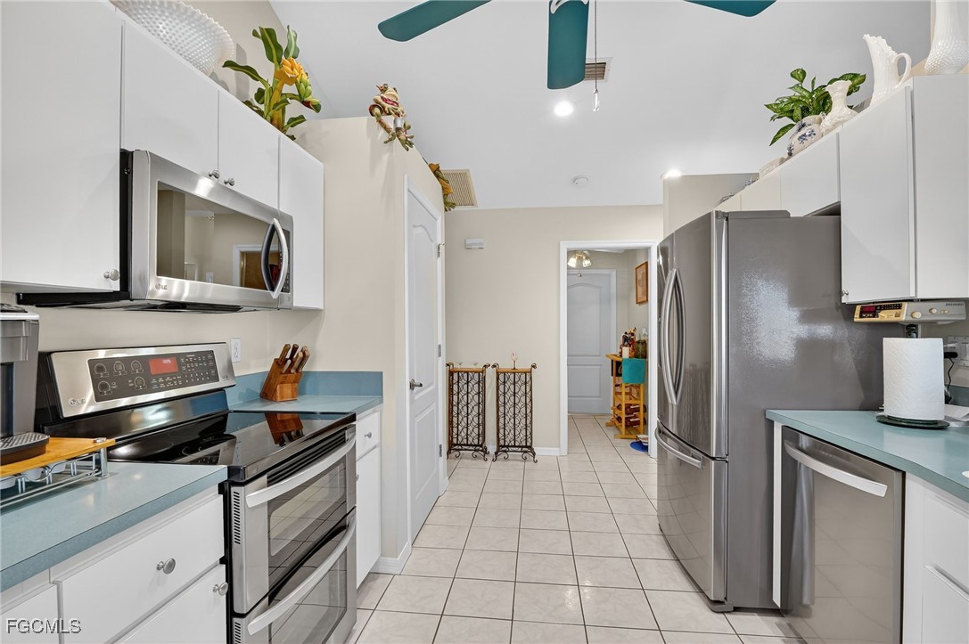 4306 Southwest 3rd Avenue Cape Coral, FL 33914 - Photo 13 of 50 a kitchen with stainless steel appliances a stove microwave and refrigerator