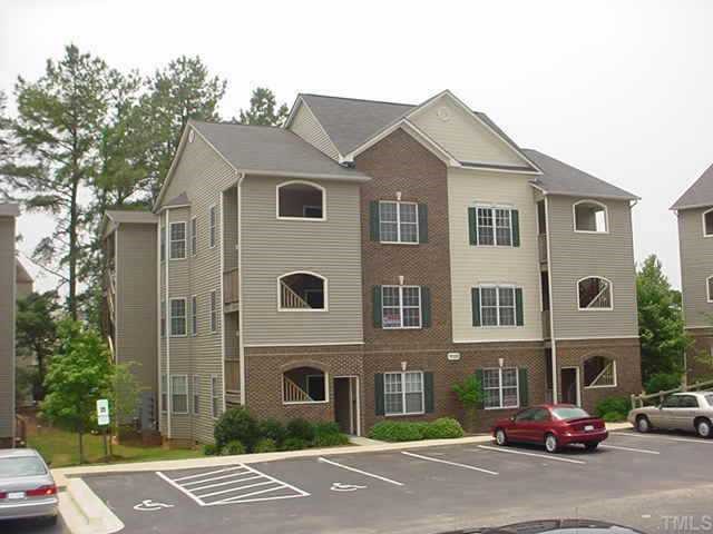 7022 Sandy Forks Road, Unit 302 Raleigh, NC 27615 - Photo 1 of 1 a front view of a building with a yard