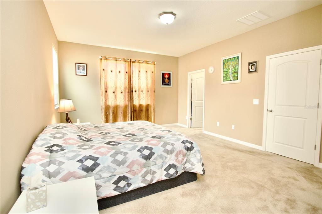 12343 Moss Lake Loop New Port Richey, FL 34655 - Photo 14 of 24 a bedroom with a bed and a window