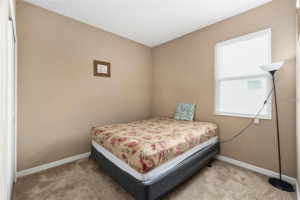 12343 Moss Lake Loop New Port Richey, FL 34655 - Photo 17 of 24 a bed sitting in a bedroom next to a window