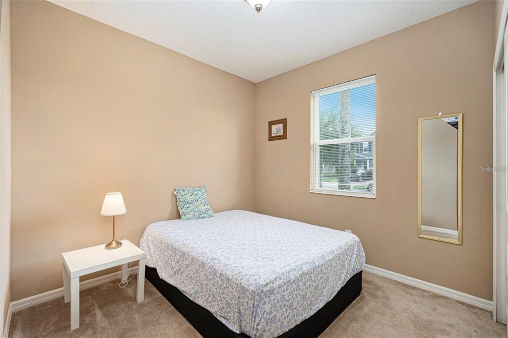 12343 Moss Lake Loop New Port Richey, FL 34655 - Photo 20 of 24 a bedroom with a bed lamp and window