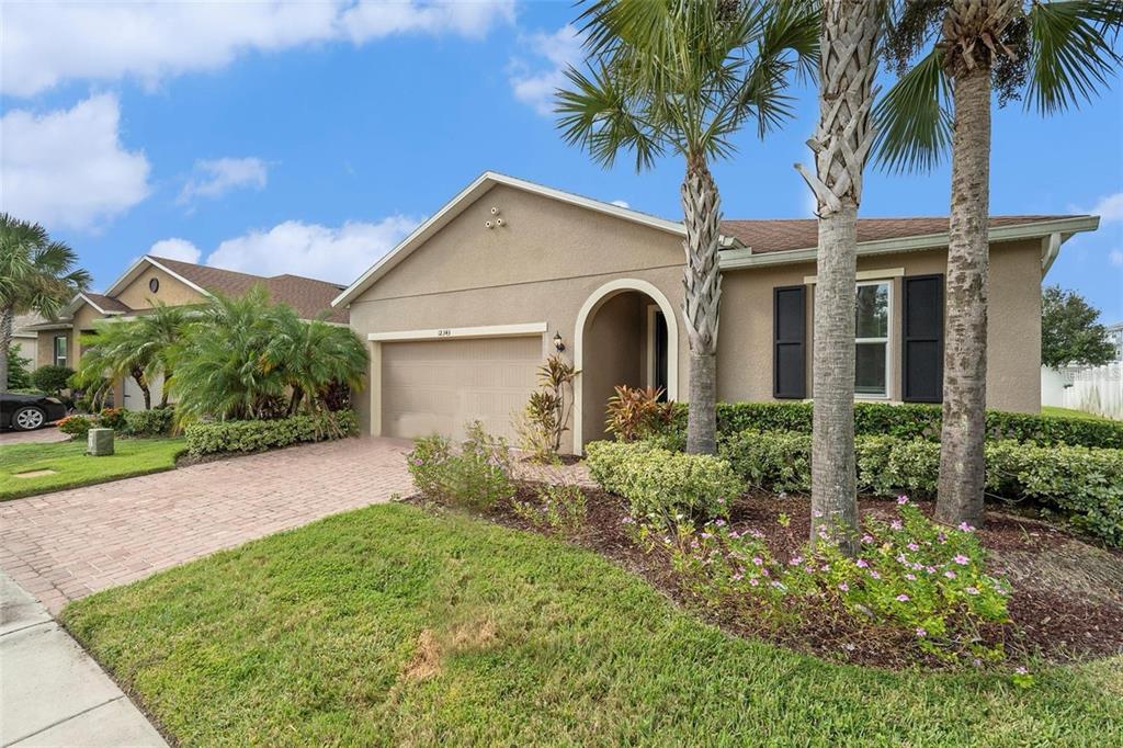 12343 Moss Lake Loop New Port Richey, FL 34655 - Photo 2 of 24 a front view of a house with a garden