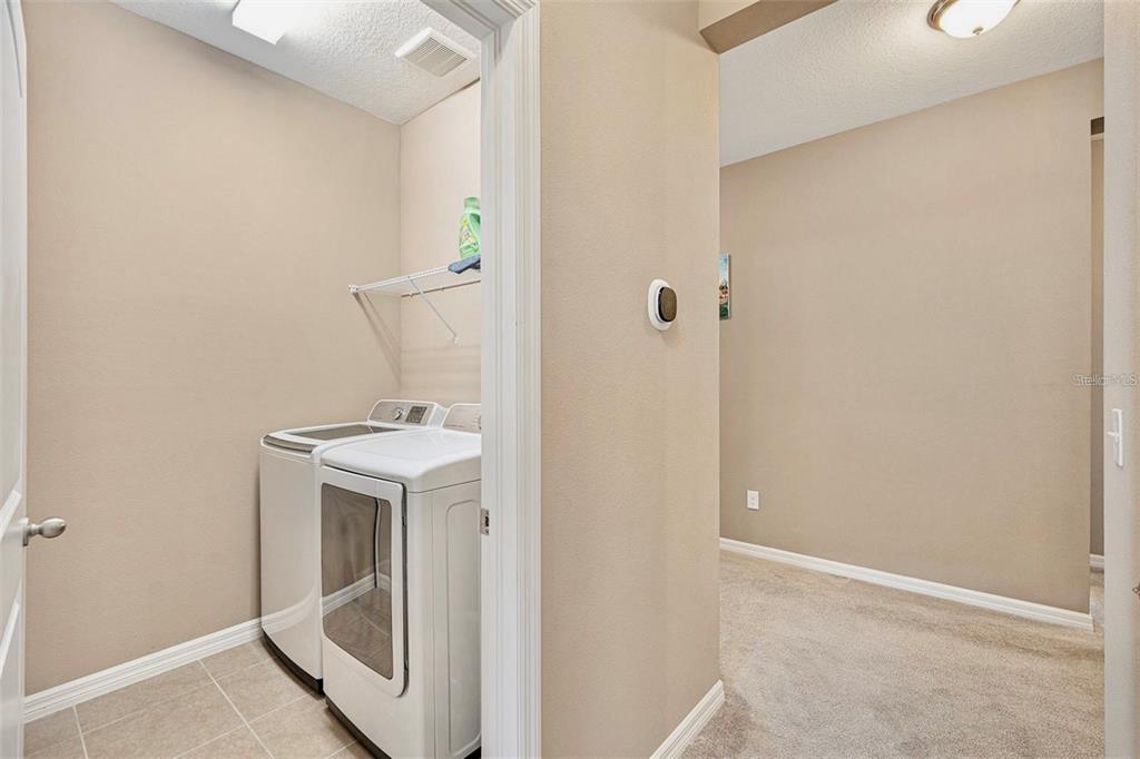 12343 Moss Lake Loop New Port Richey, FL 34655 - Photo 21 of 24 a utility room with a sink dryer and washer