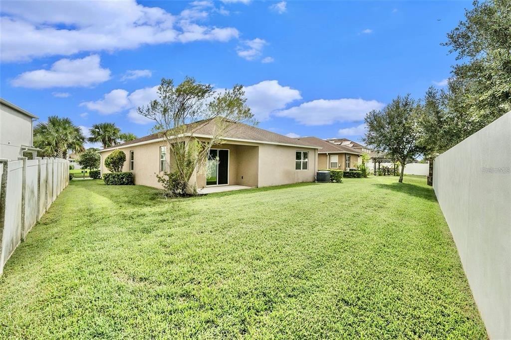 12343 Moss Lake Loop New Port Richey, FL 34655 - Photo 22 of 24 a front view of a house with a yard