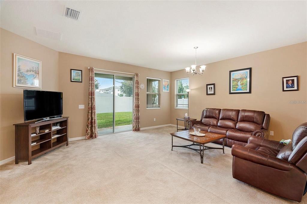 12343 Moss Lake Loop New Port Richey, FL 34655 - Photo 9 of 24 a living room with furniture and a flat screen tv