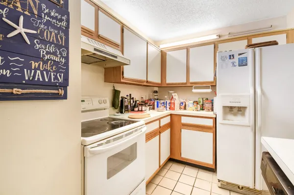 a kitchen with stainless steel appliances a refrigerator and a stove top oven