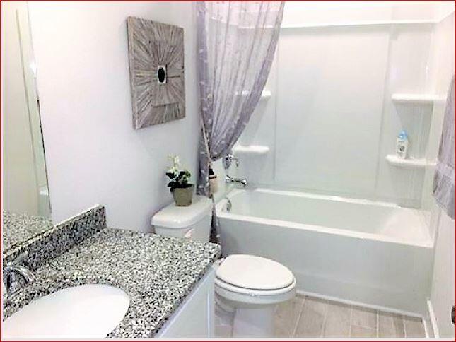 824 Otto Loop Crestview, FL 32539 - Photo 19 of 36 a bathroom with a sink toilet and bathtub