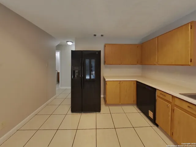 a kitchen with a cabinets and a refrigerator
