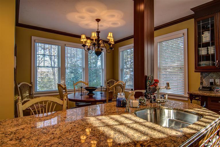 3 Harbor Ridge Road Mashpee, MA 02649 - Photo 12 of 34 a kitchen with sink refrigerator and large windows