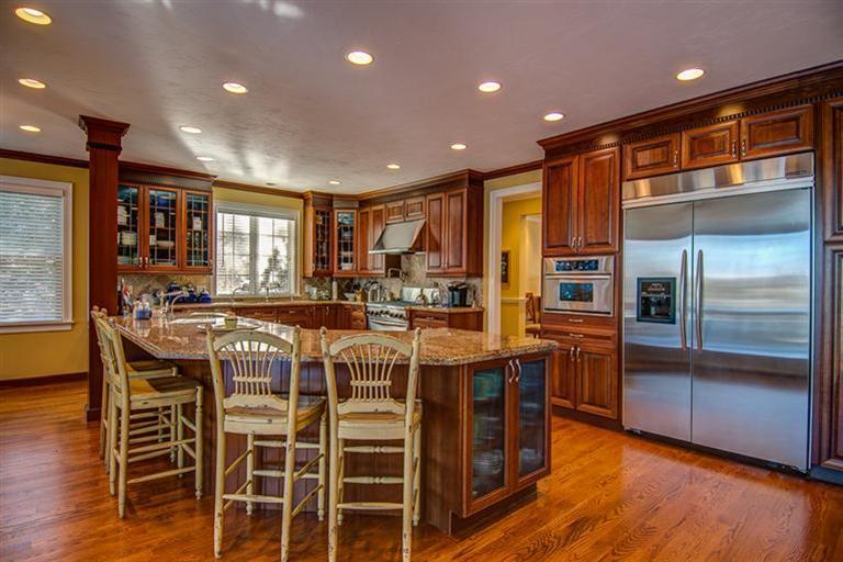 3 Harbor Ridge Road Mashpee, MA 02649 - Photo 13 of 34 a kitchen with stainless steel appliances kitchen island granite countertop a refrigerator and cabinets