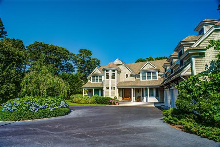 3 Harbor Ridge Road Mashpee, MA 02649 - Photo 2 of 34 a front view of a house with a garden