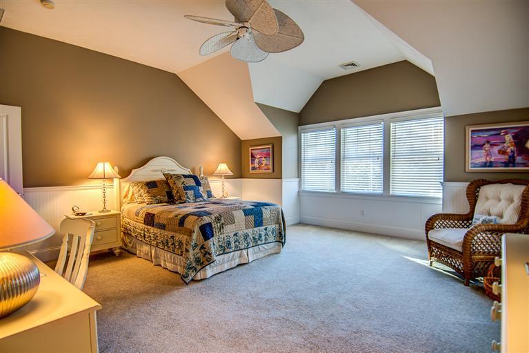 3 Harbor Ridge Road Mashpee, MA 02649 - Photo 26 of 34 a spacious bedroom with a bed and a chandelier