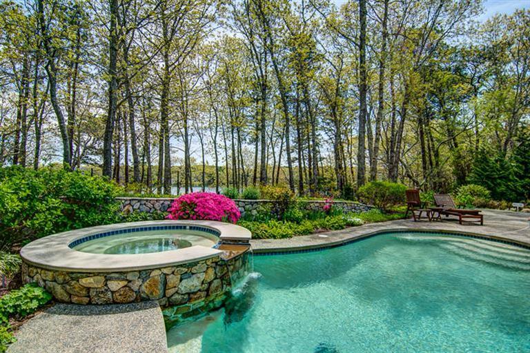 3 Harbor Ridge Road Mashpee, MA 02649 - Photo 3 of 34 a wooden bench sitting in the middle of a park
