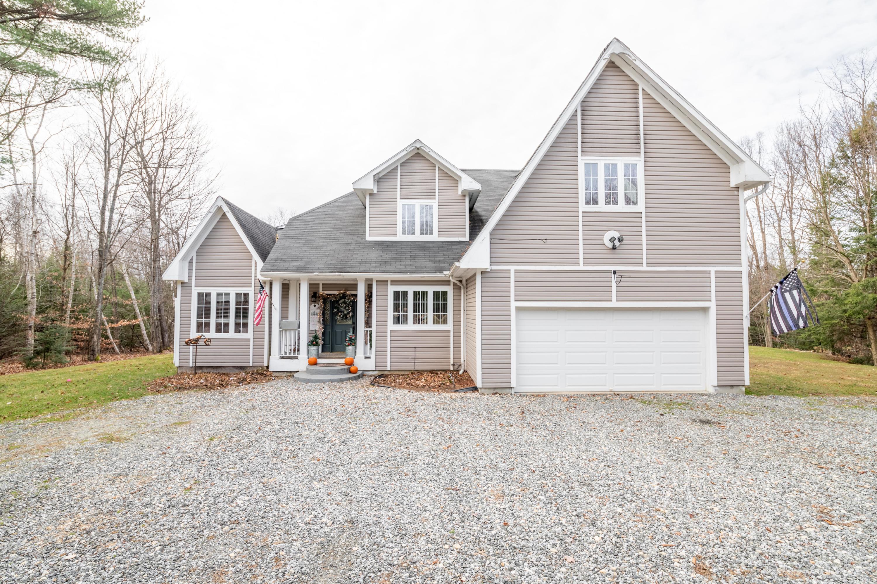 29 Valley View Road Becket, MA 01223 - Photo 1 of 36 a front view of a house with a yard and garage