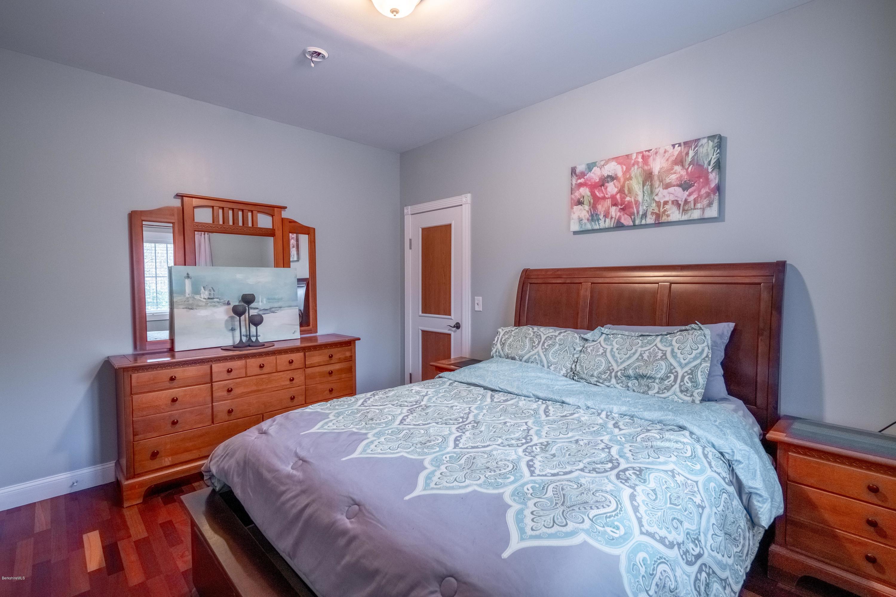 29 Valley View Road Becket, MA 01223 - Photo 13 of 36 a bedroom with a bed and a dresser in it