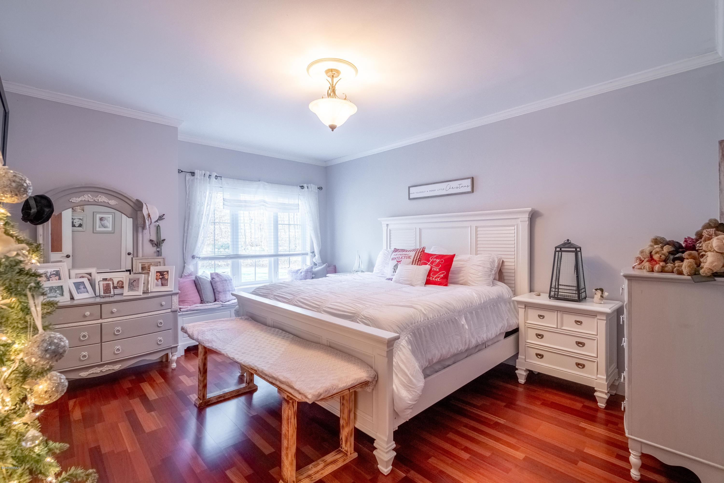 29 Valley View Road Becket, MA 01223 - Photo 16 of 36 a bedroom with a bed and wooden floor