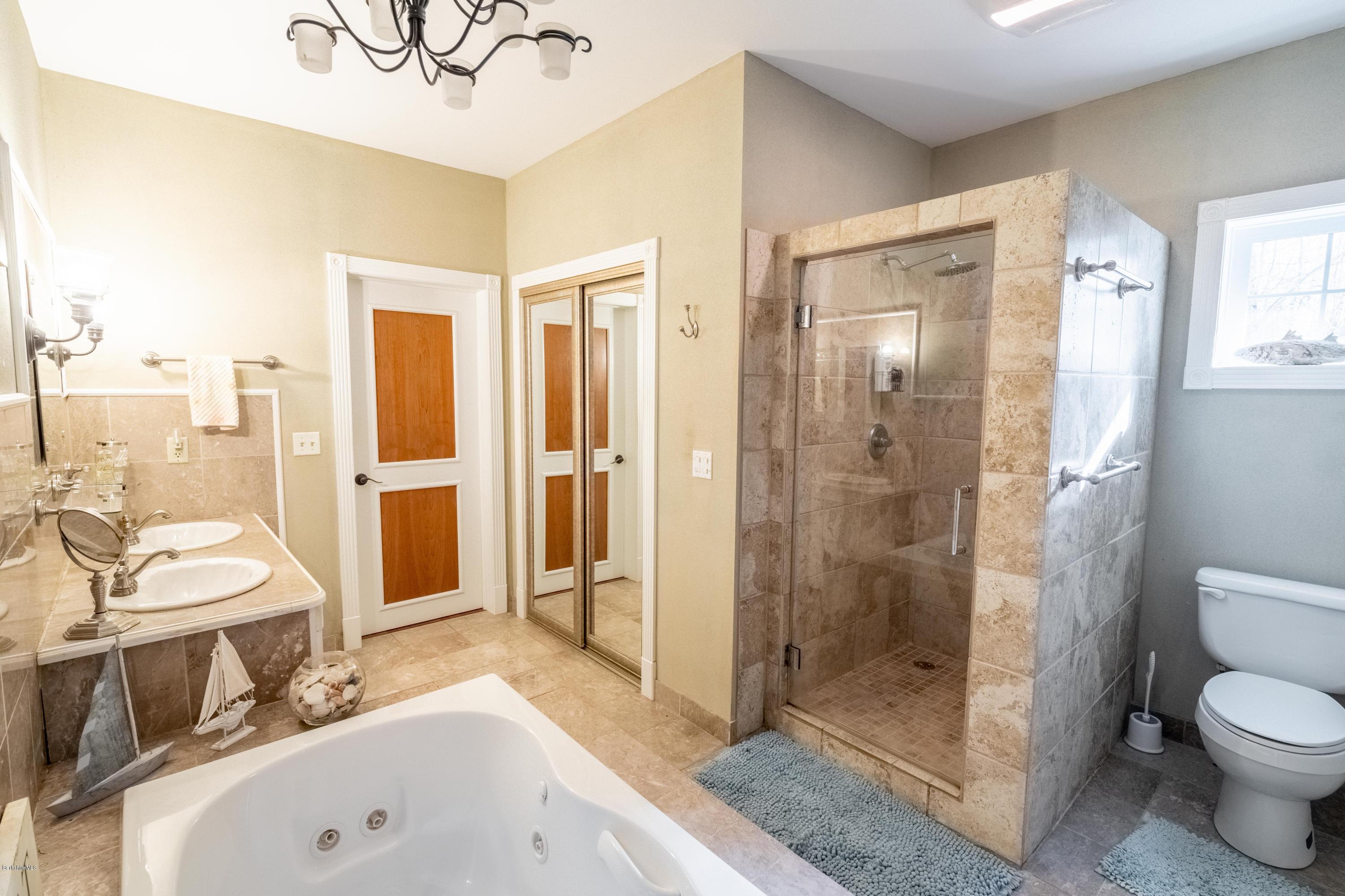 29 Valley View Road Becket, MA 01223 - Photo 19 of 36 a bathroom with a sink a toilet and shower