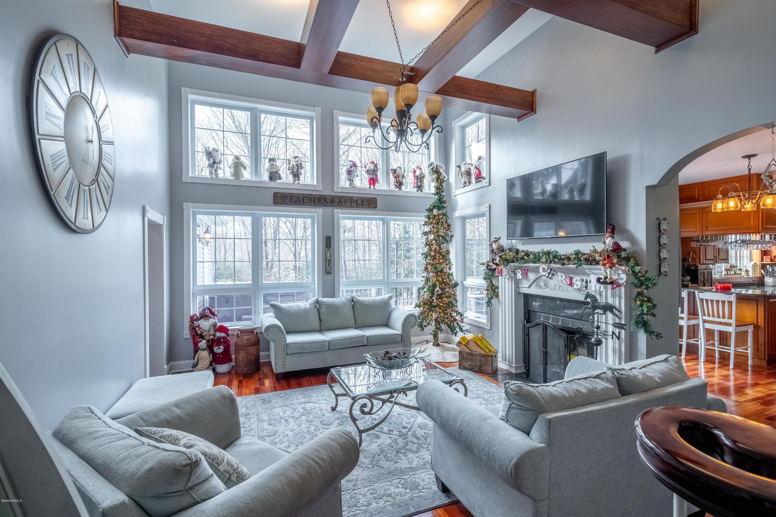29 Valley View Road Becket, MA 01223 - Photo 20 of 36 a living room with furniture a flat screen tv and a fireplace