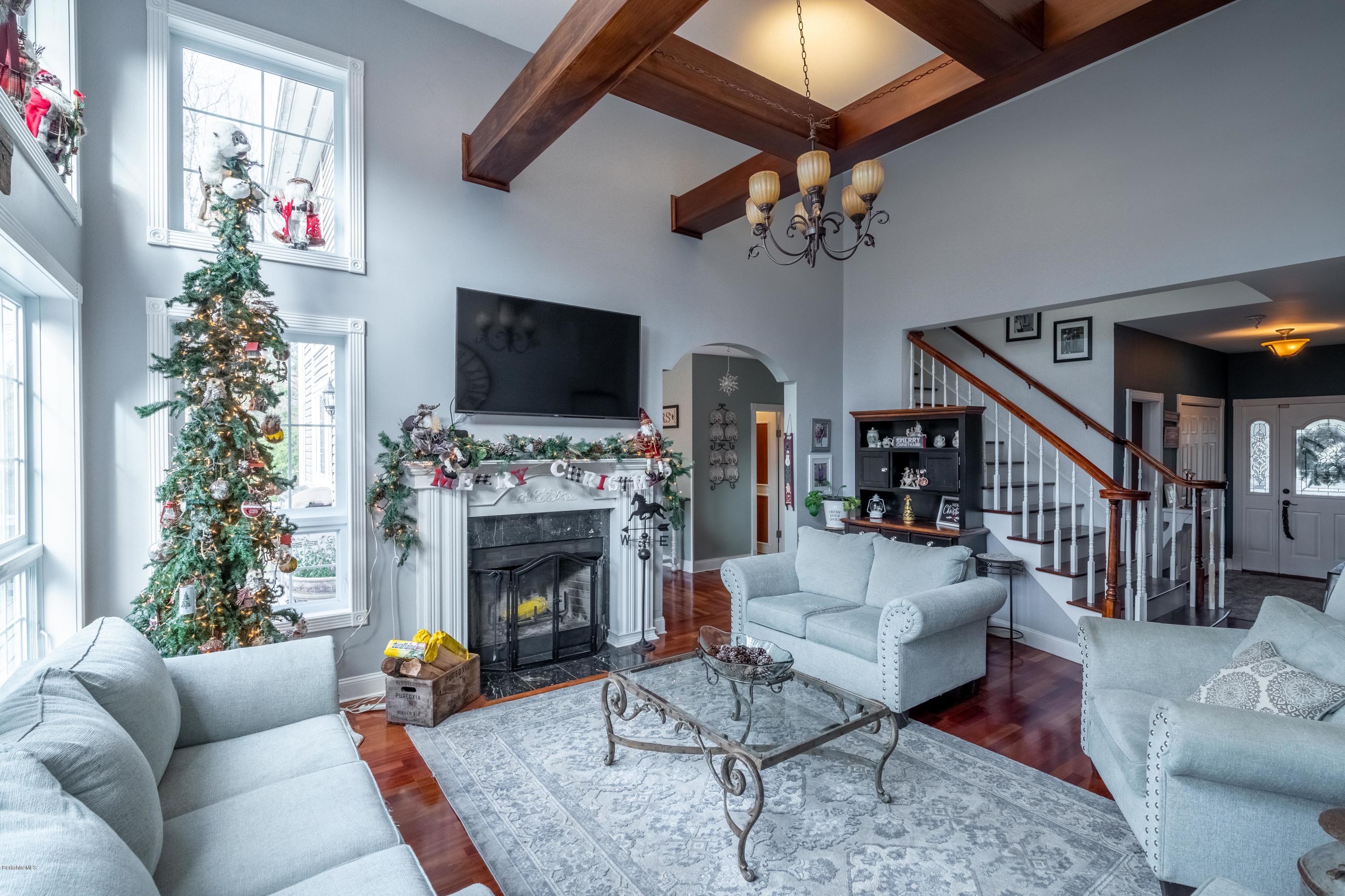 29 Valley View Road Becket, MA 01223 - Photo 21 of 36 a living room with furniture a flat screen tv and a fireplace