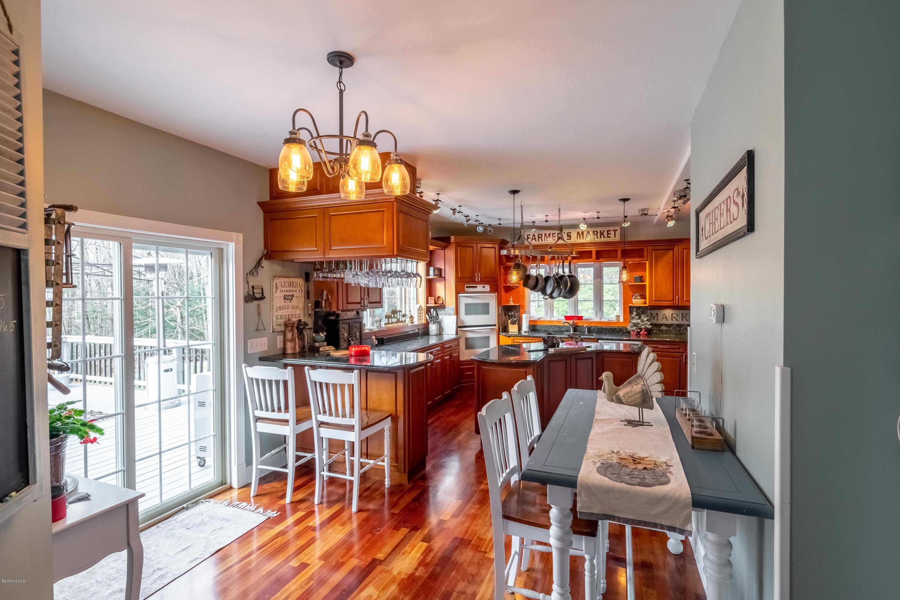 29 Valley View Road Becket, MA 01223 - Photo 22 of 36 a view of a dining room with furniture wooden floor and chandelier