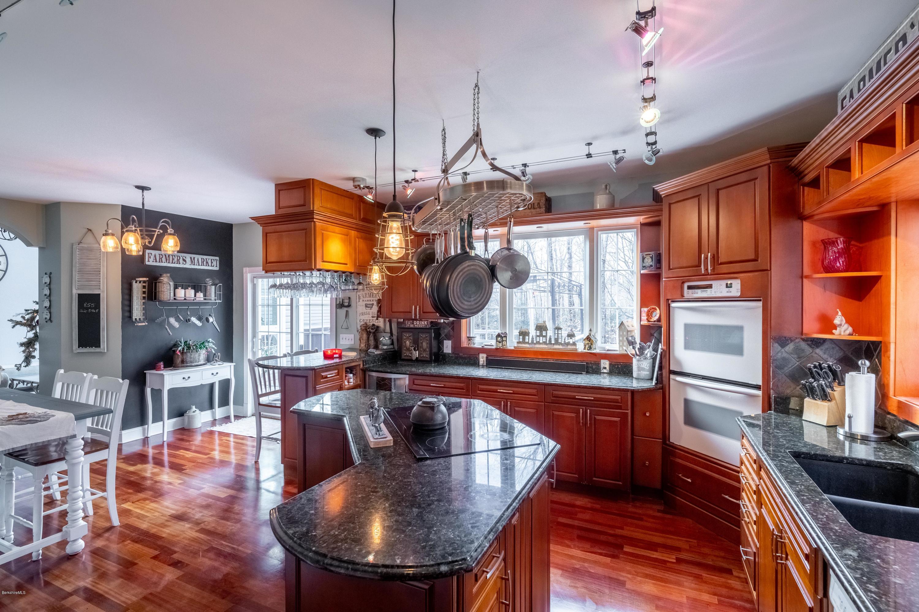 29 Valley View Road Becket, MA 01223 - Photo 23 of 36 a kitchen with stainless steel appliances granite countertop a stove refrigerator and chandelier