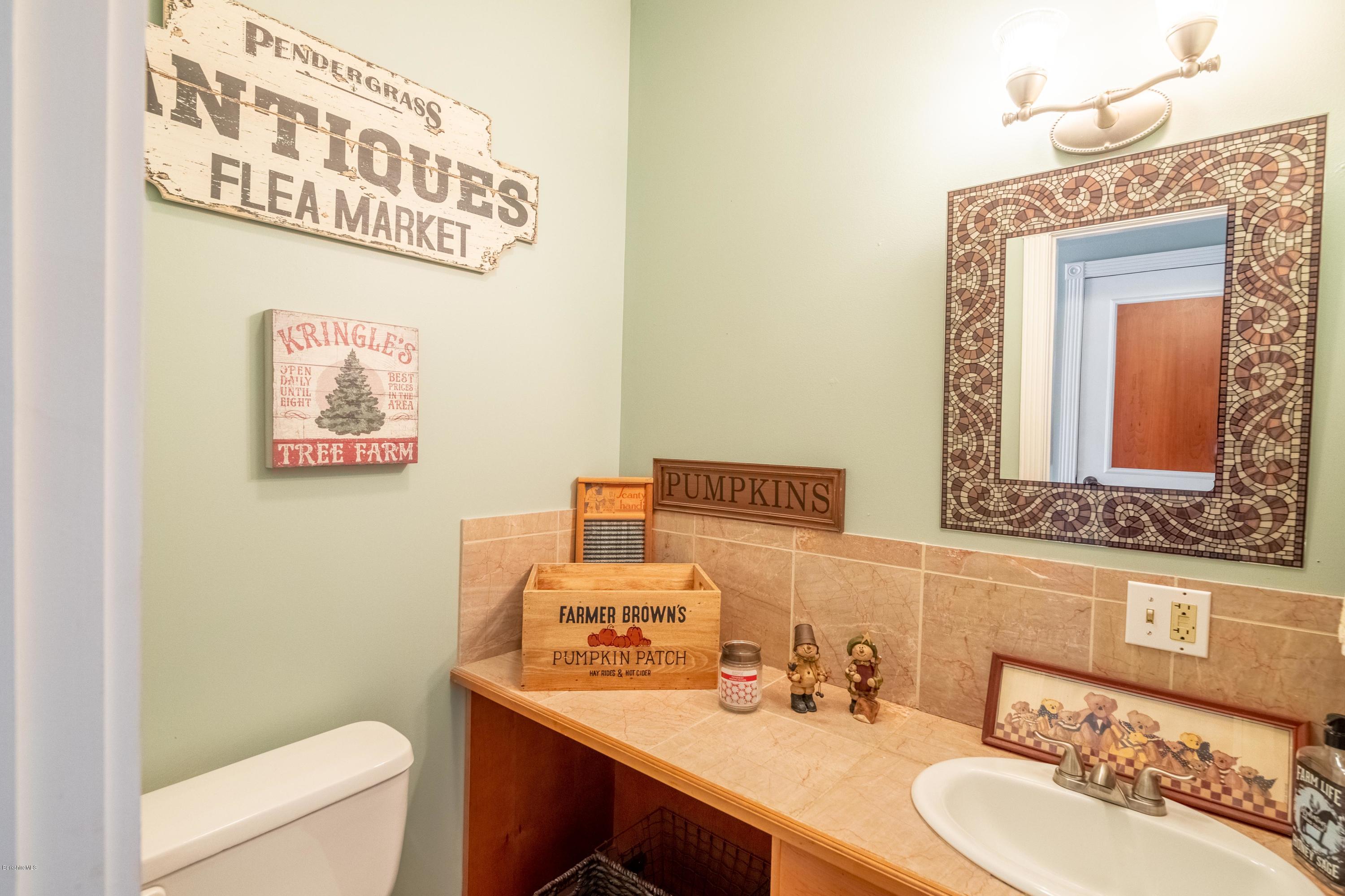 29 Valley View Road Becket, MA 01223 - Photo 26 of 36 a bathroom with a sink mirror vanity and toilet