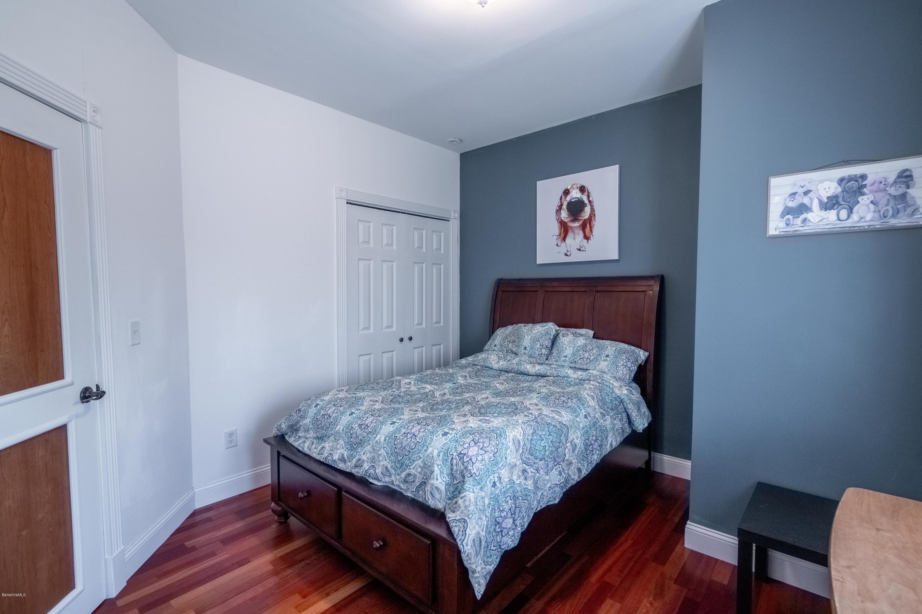 29 Valley View Road Becket, MA 01223 - Photo 8 of 36 a bed sitting in a bedroom next to a window with wooden floor