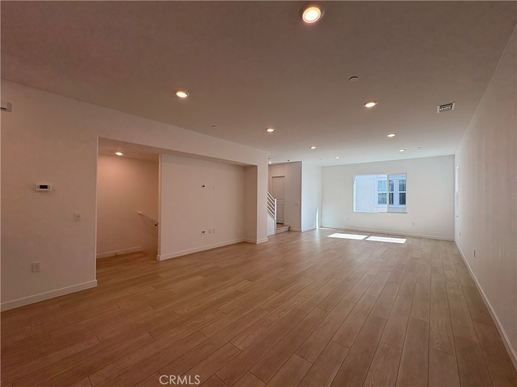 2540 Everly Street El Monte, CA 91733 - Photo 11 of 28 an empty room with wooden floor and windows