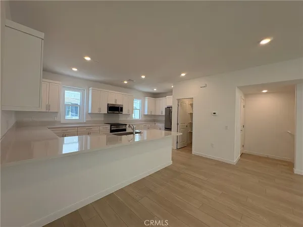 a kitchen with a sink a stove and cabinets