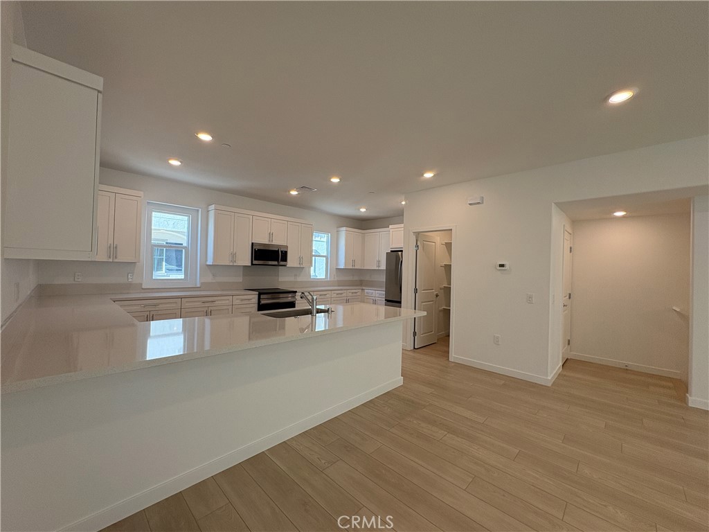 2540 Everly Street El Monte, CA 91733 - Photo 5 of 28 a view of kitchen with stainless steel appliances granite countertop a refrigerator a sink a stove and a wooden floors