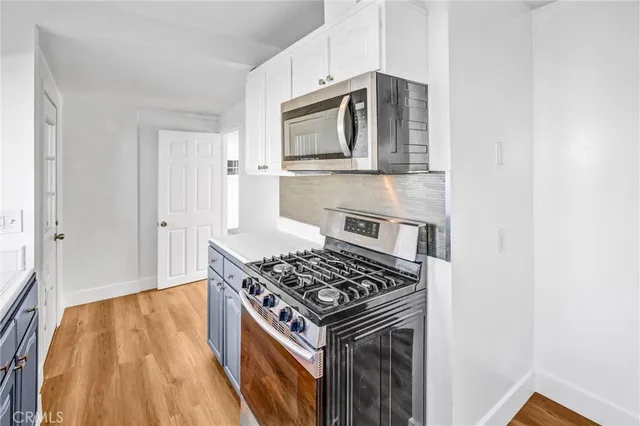 a kitchen with a stove and a microwave