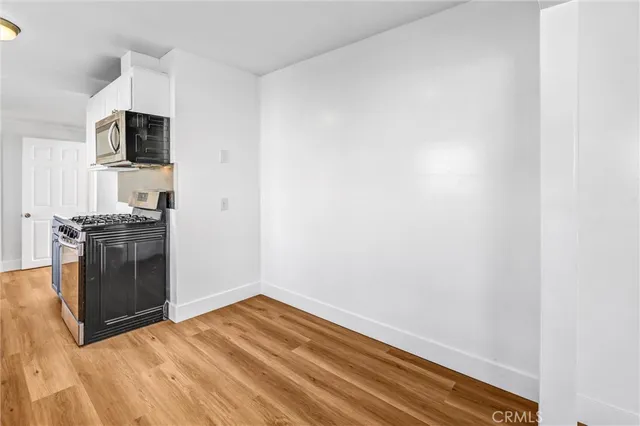 a view of kitchen with microwave and cabinets