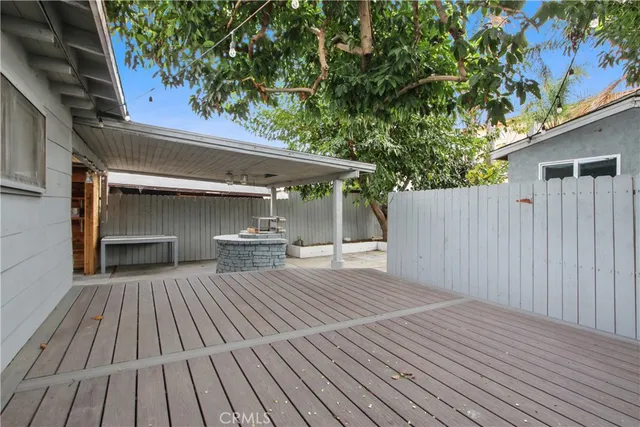 a view of backyard with a deck and wooden floor