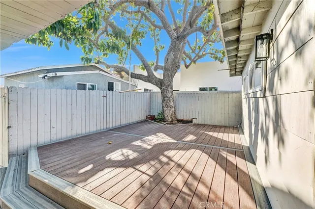 a view of a backyard with wooden fence