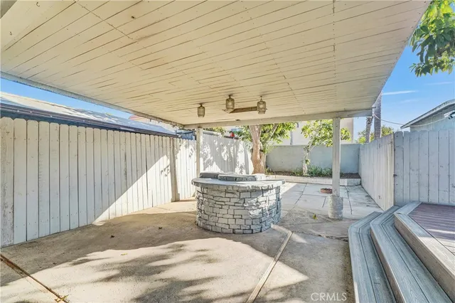 a building outdoor space with patio furniture and potted plants